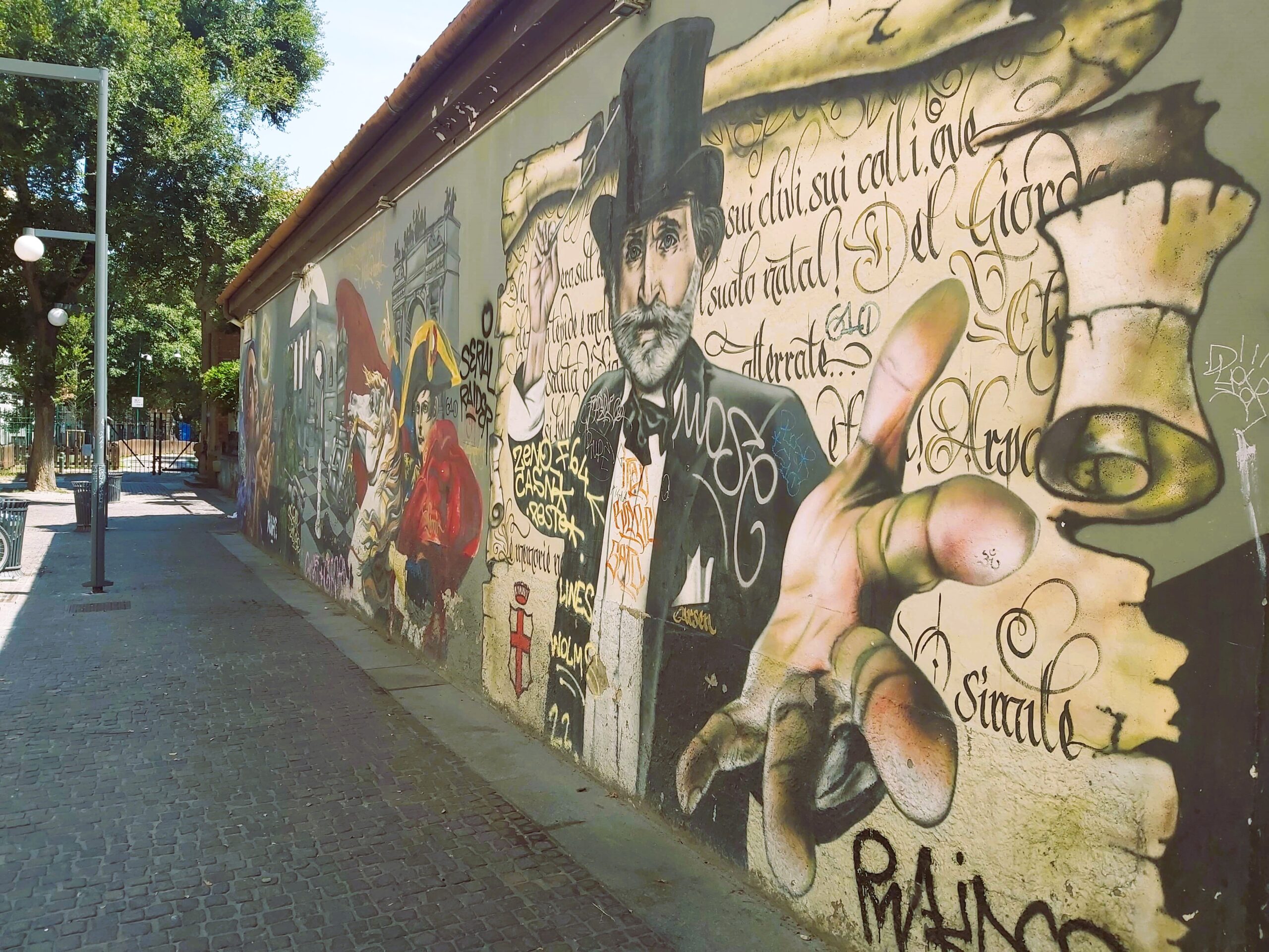 A graffiti image of a man wearing a top hat in Milan, Italy