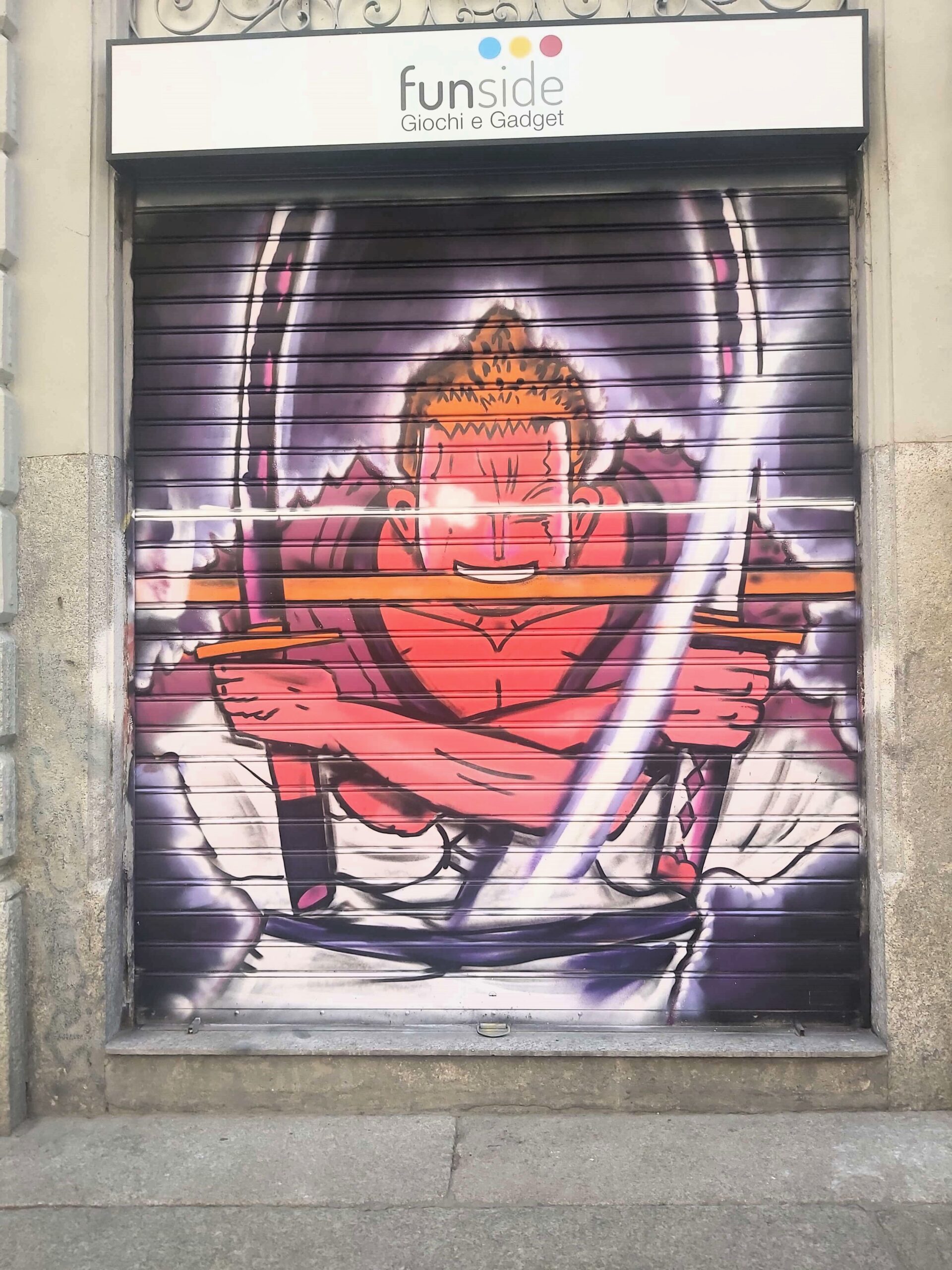 A graffiti image of a cartoon character with swords in Milan, Italy