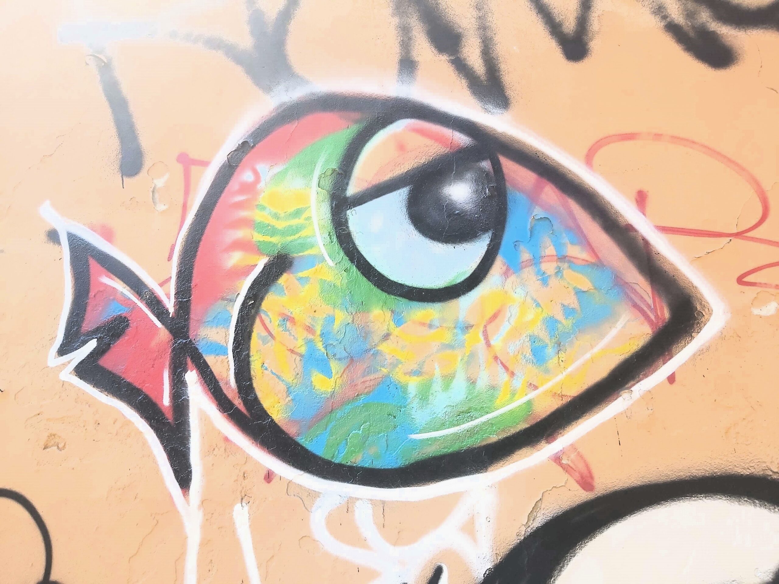 A graffiti image of a multi-coloured fish in Milan, Italy