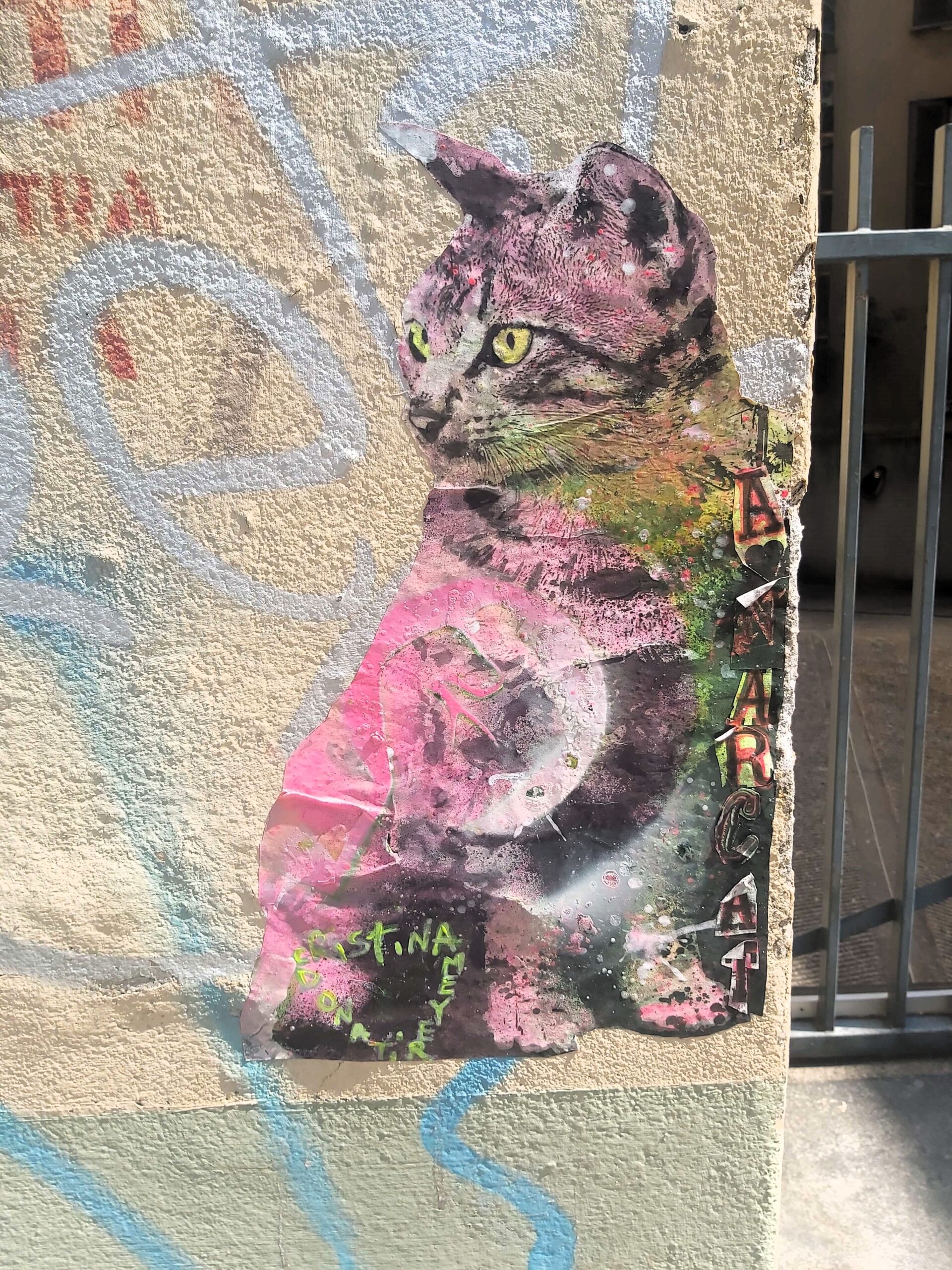 A graffiti image of a pink cat in Milan, Italy