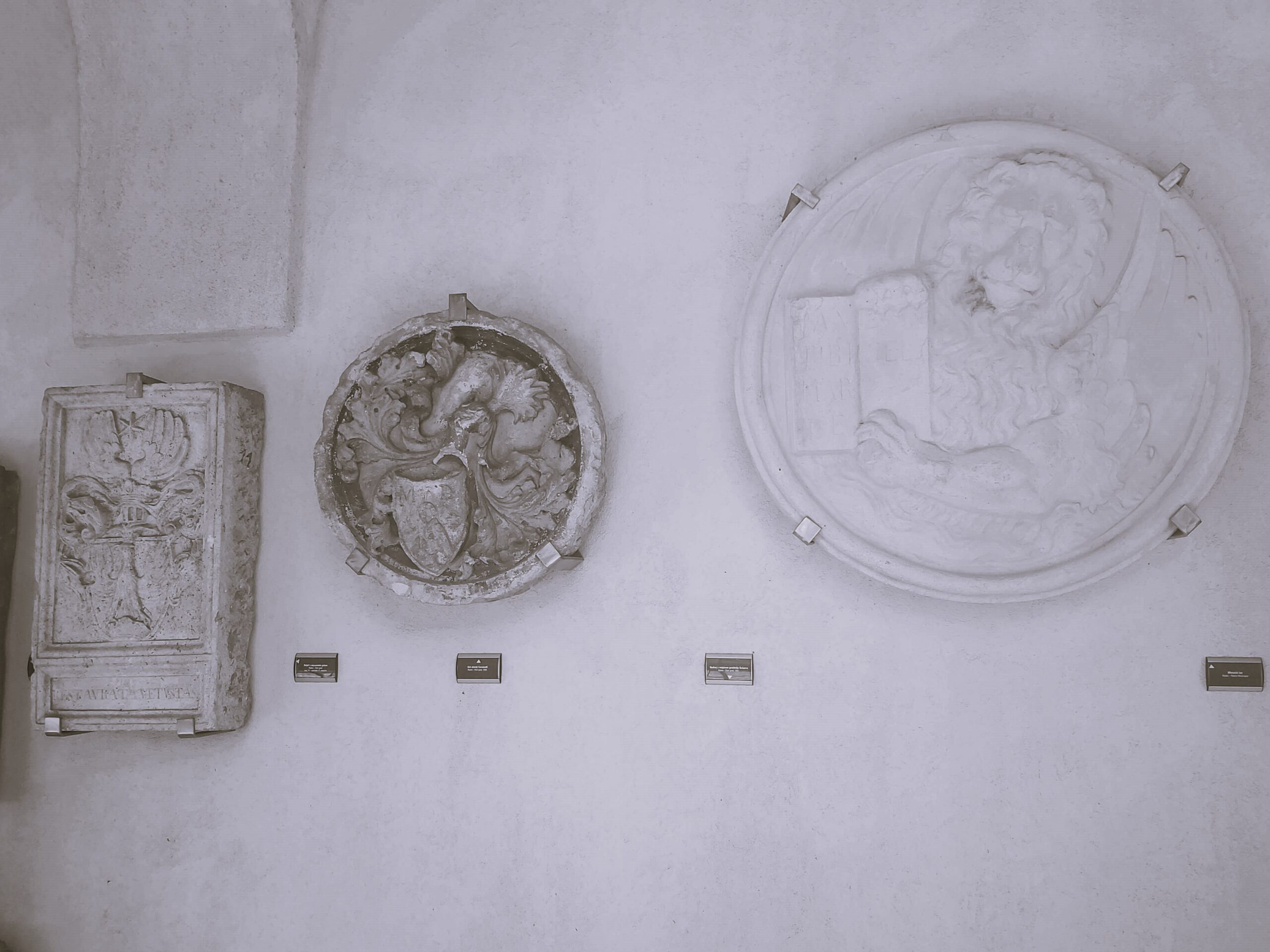 Several ancient stone plaques on a white wall, Rijeka, Croatia