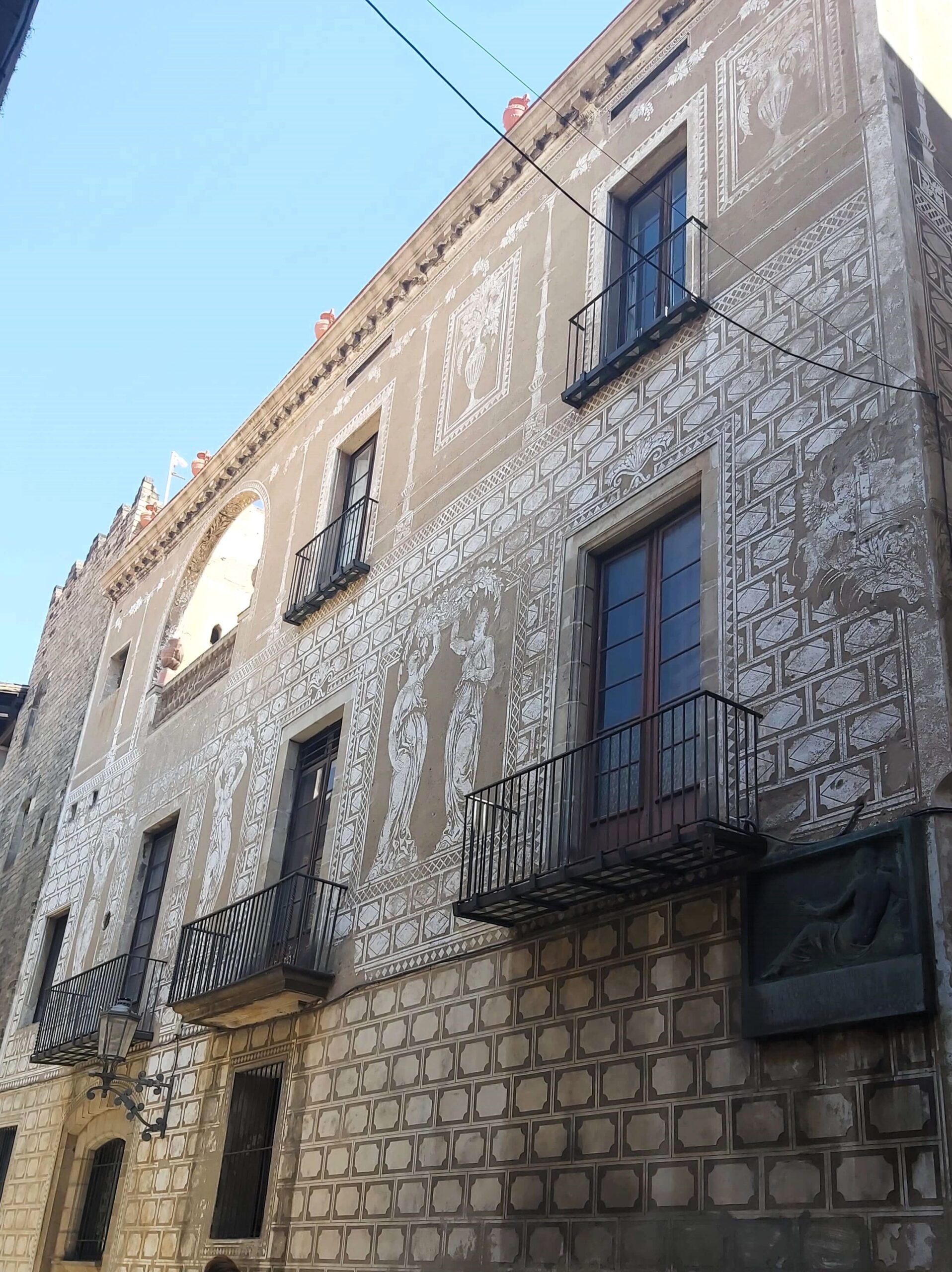 A decorated building in brown and cream tones in Barcelona, Spain