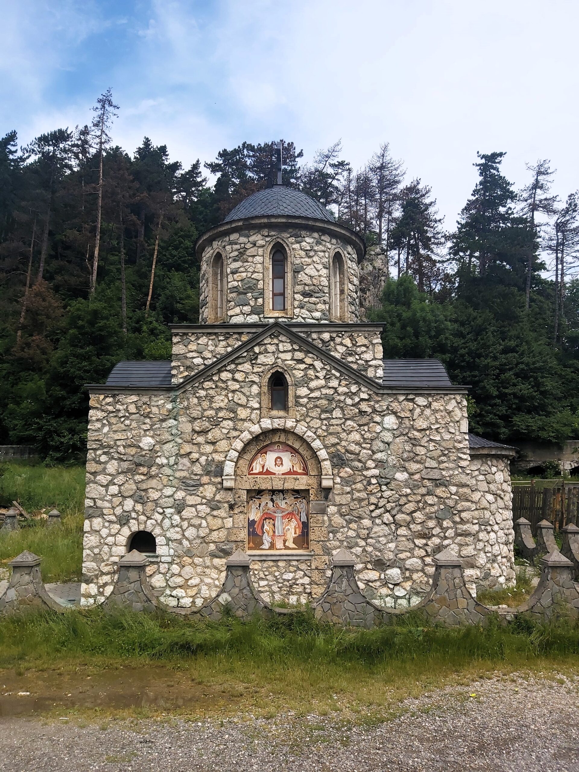 A small church with trees in Bran, Romania