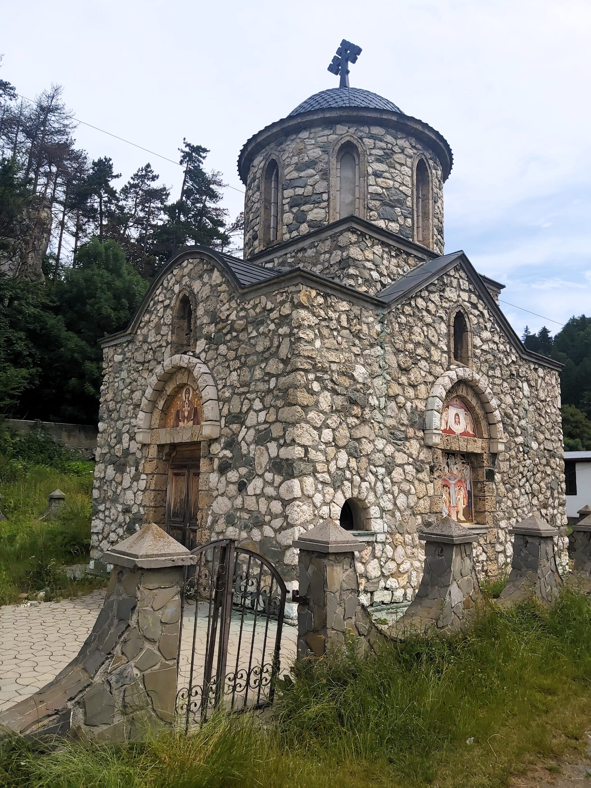 A small church with murals painted on in Bran, Romania