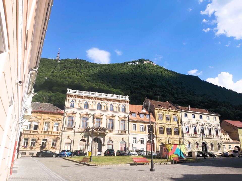 Brasov, Romania. Colourful row of buildings with Hollywood-style letters in the backdrop