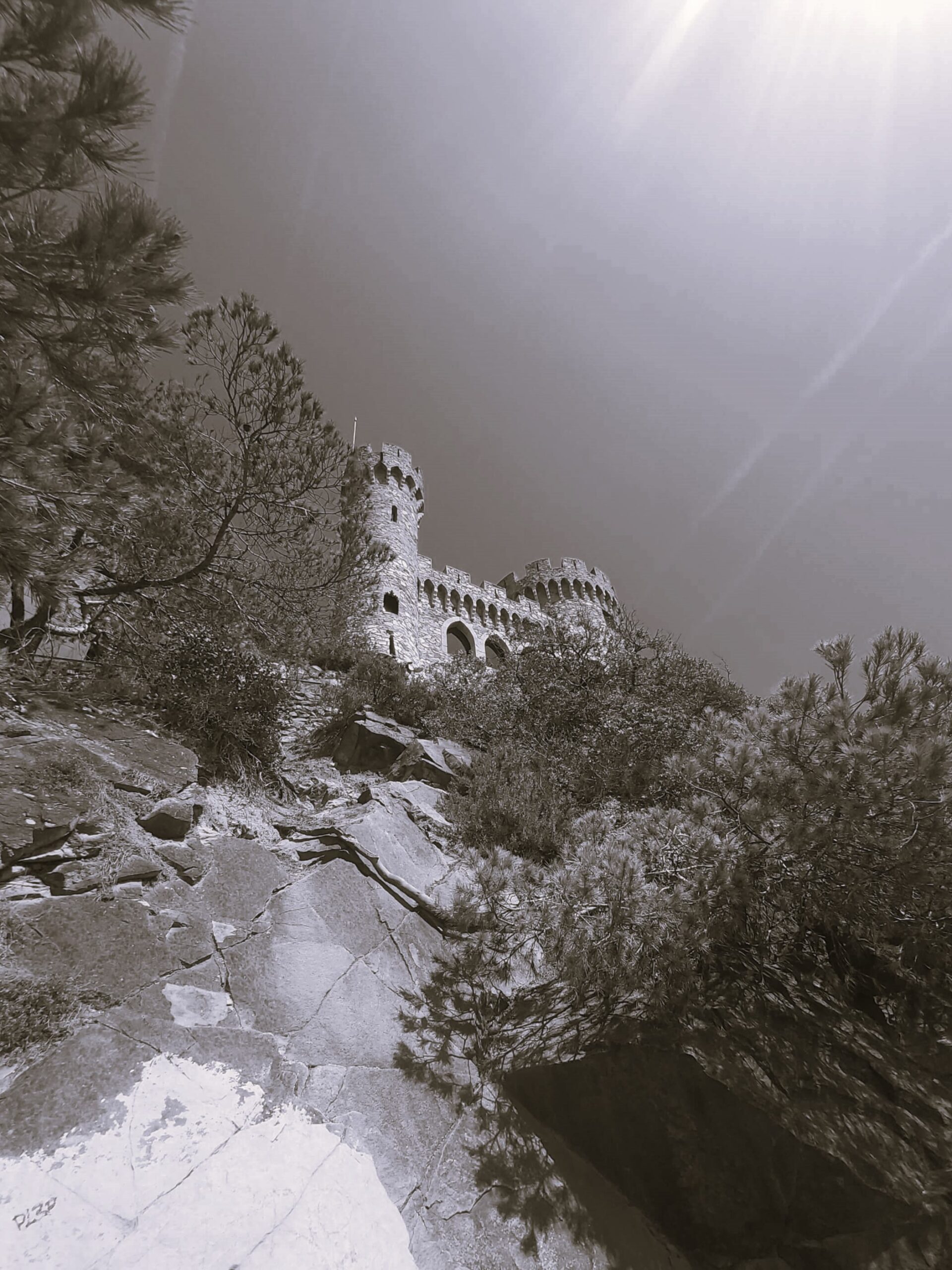 Black and white shot of castle on the cliff in Lloret de Mar, Spain
