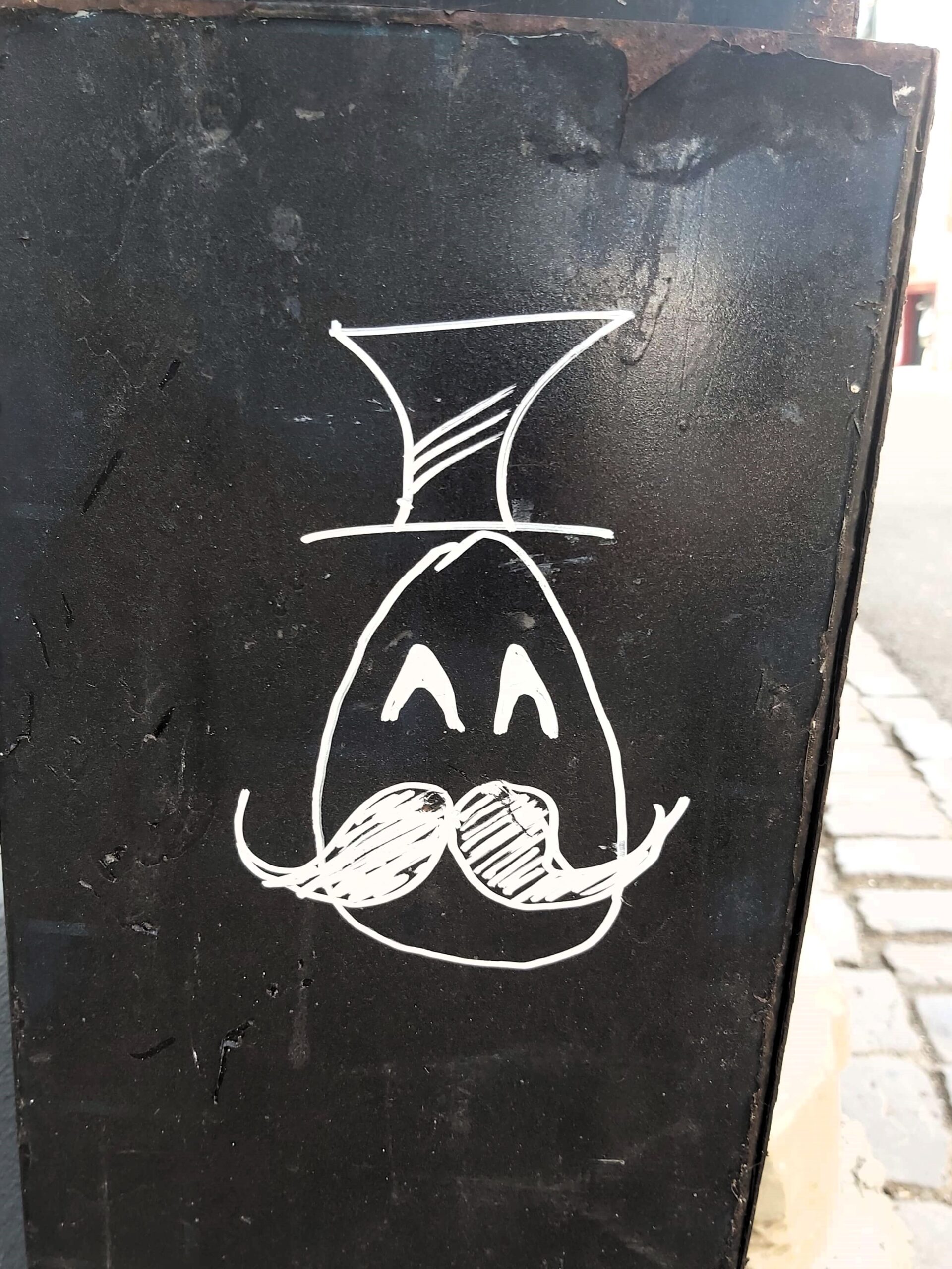 Graffiti in Timisoara, Romania. Face and top hat