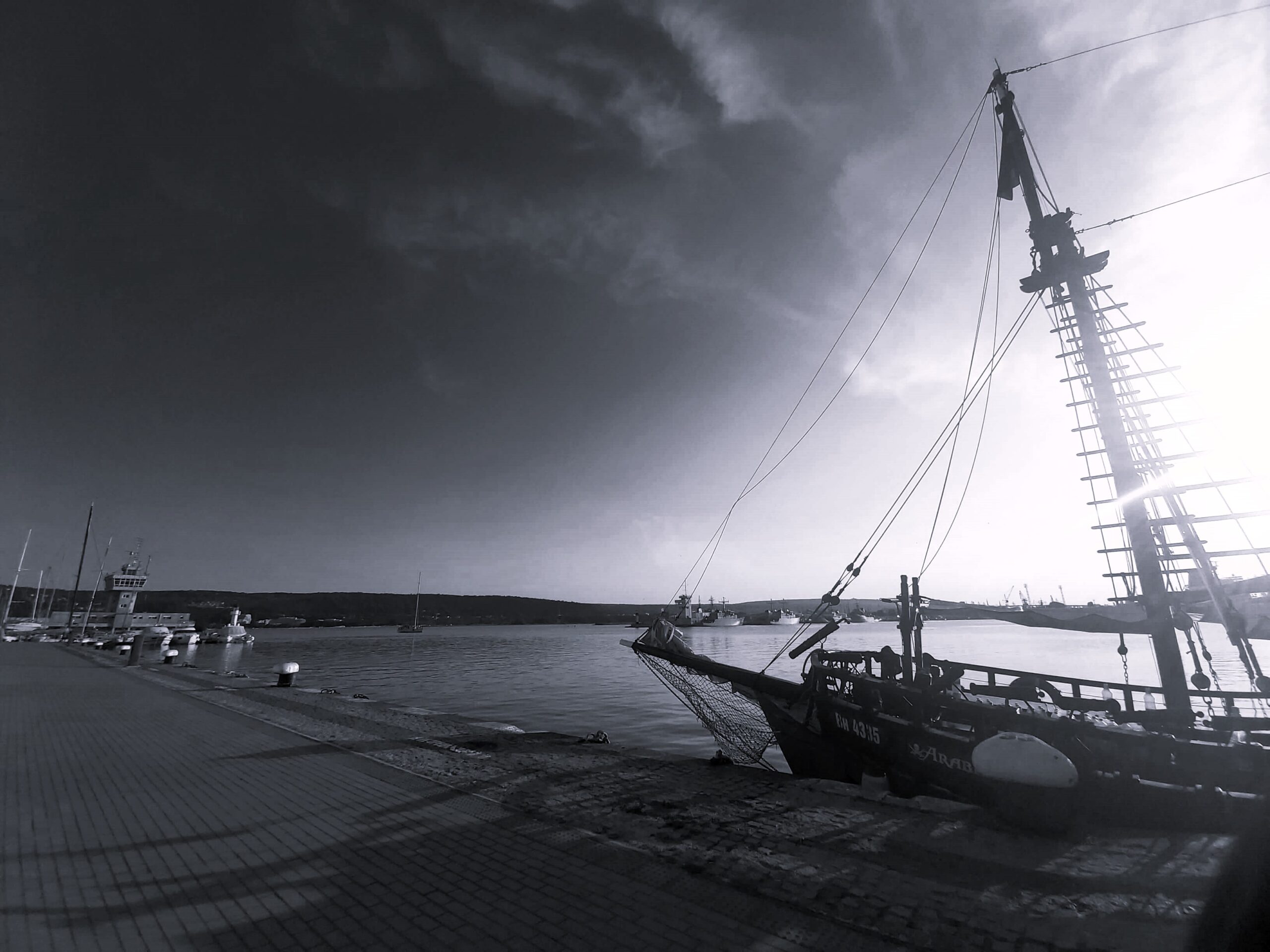 A black and white picture of a docked boat, Varna, Bulgaria