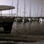 A black and white shot of boats in the harbour at Pula, Croatia