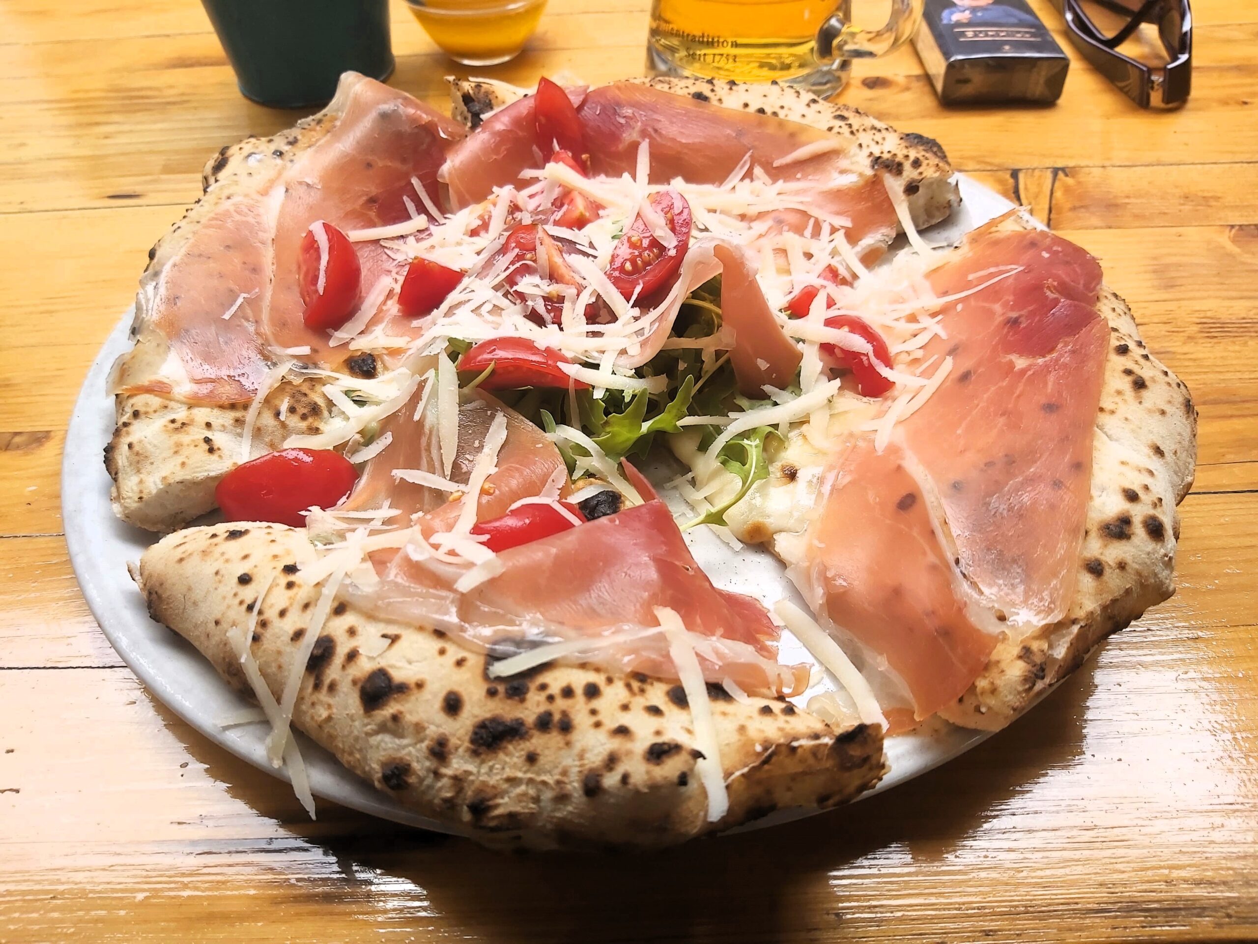 A pizza with fresh ham, cheese and tomatoes in La Pizza Napoletana, Timisoara, Romania