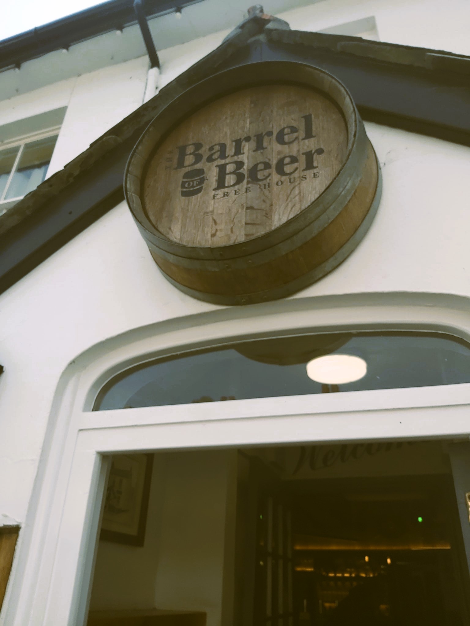 The sign above the door at the Barrel of Beer pub in Beer, Devon, England.
