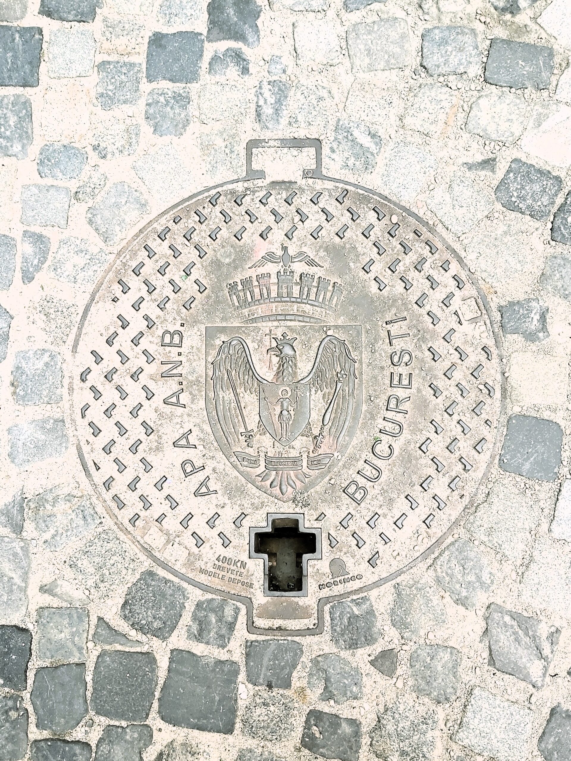 A drain cover with eagle coat of arms in București, Romania