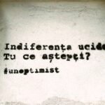 A quote graffitied on a wall, reading "indiferenta ucide tu ce astepti #unoptimist" in București, Romania