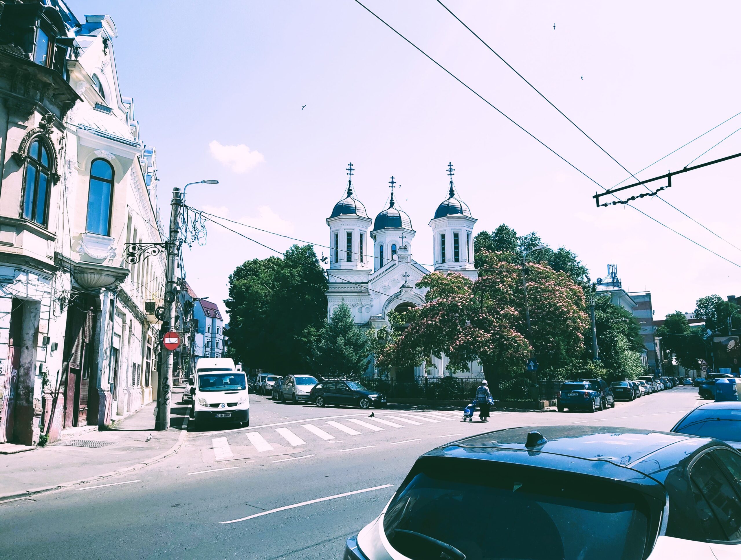 A white church next to a road in București, Romania