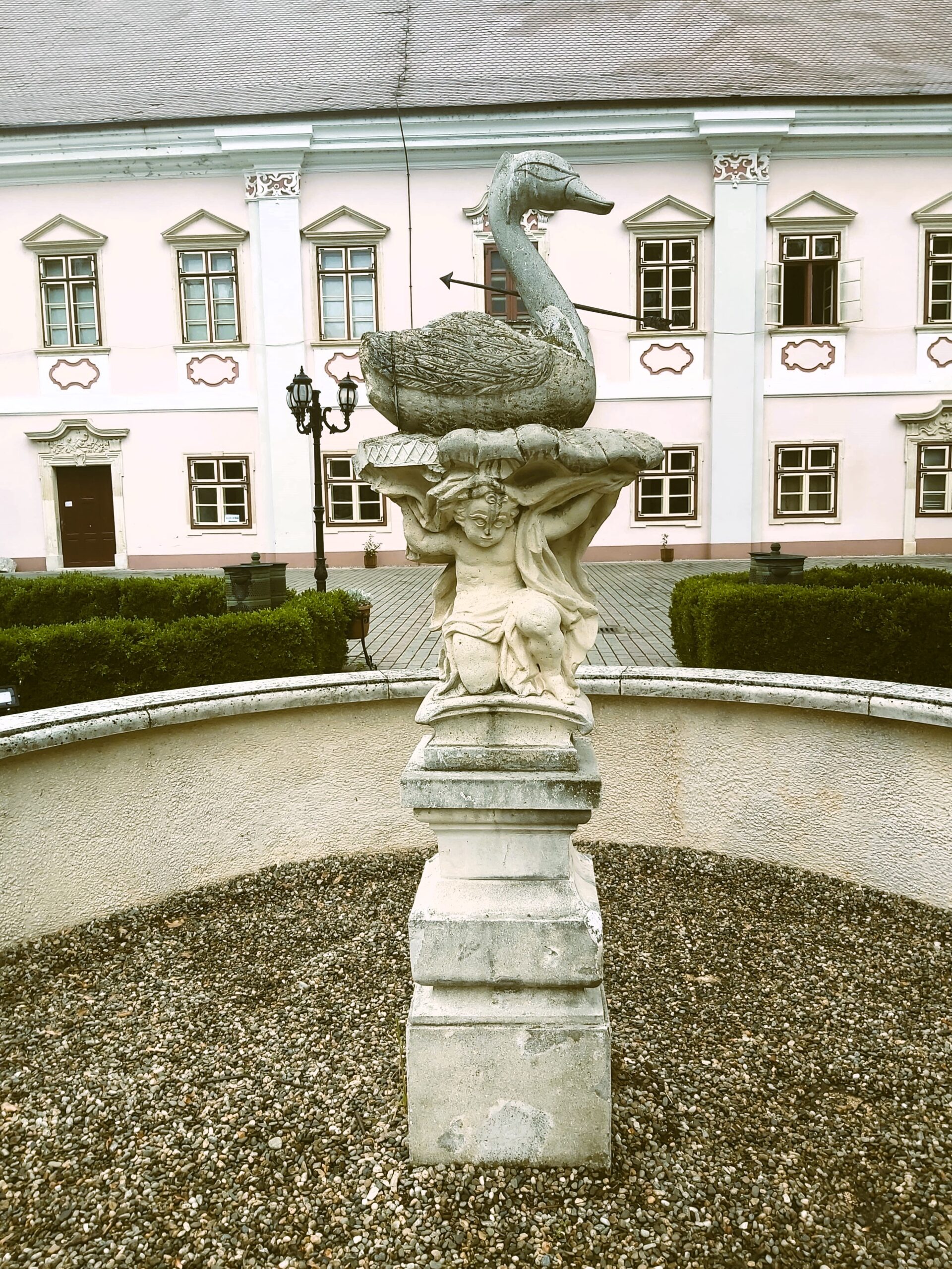 A carved fountain of a goose pierced with an arrow in Deva, Romania