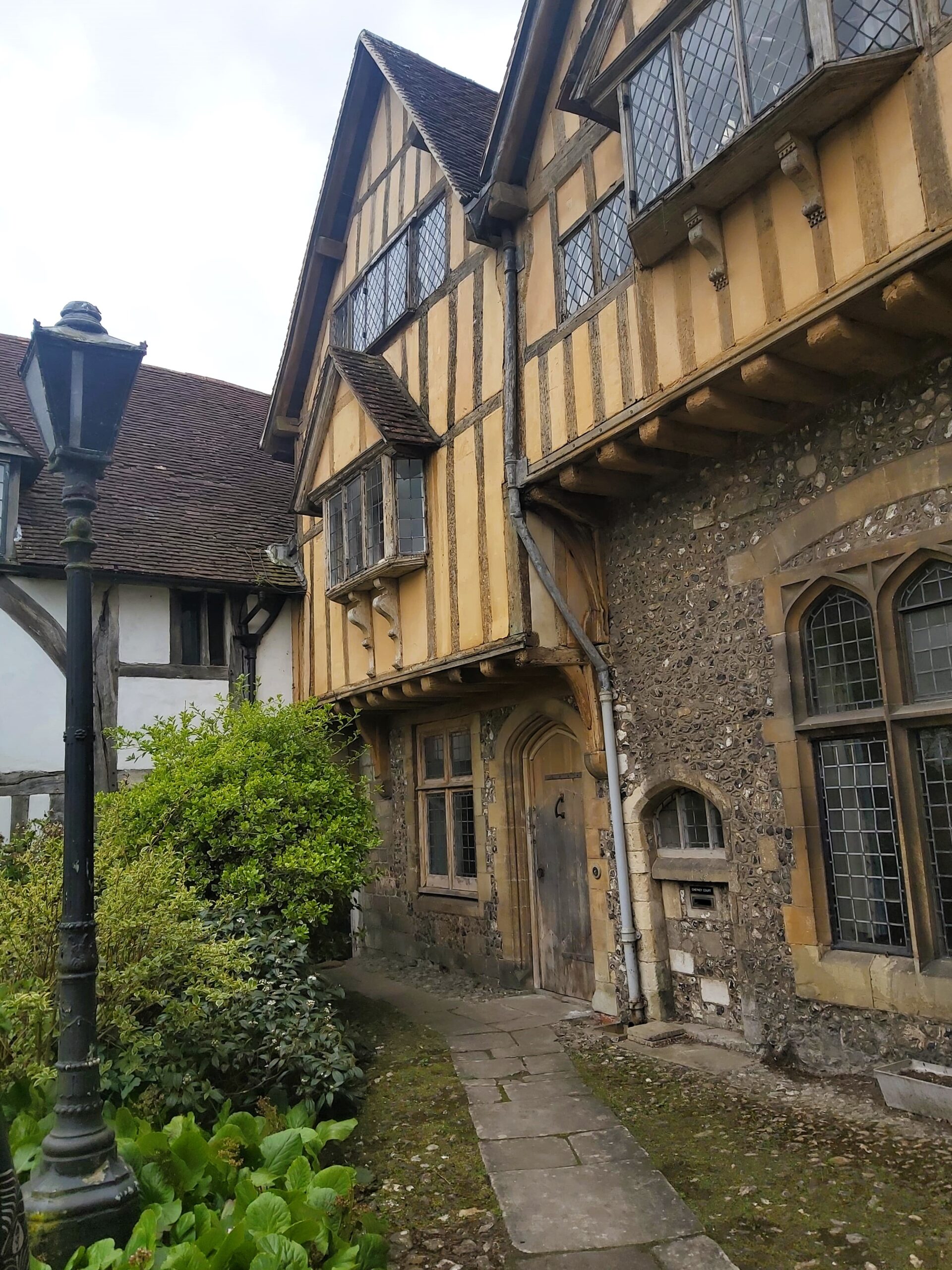 An old yellow, timber and stone building in Winchester, England