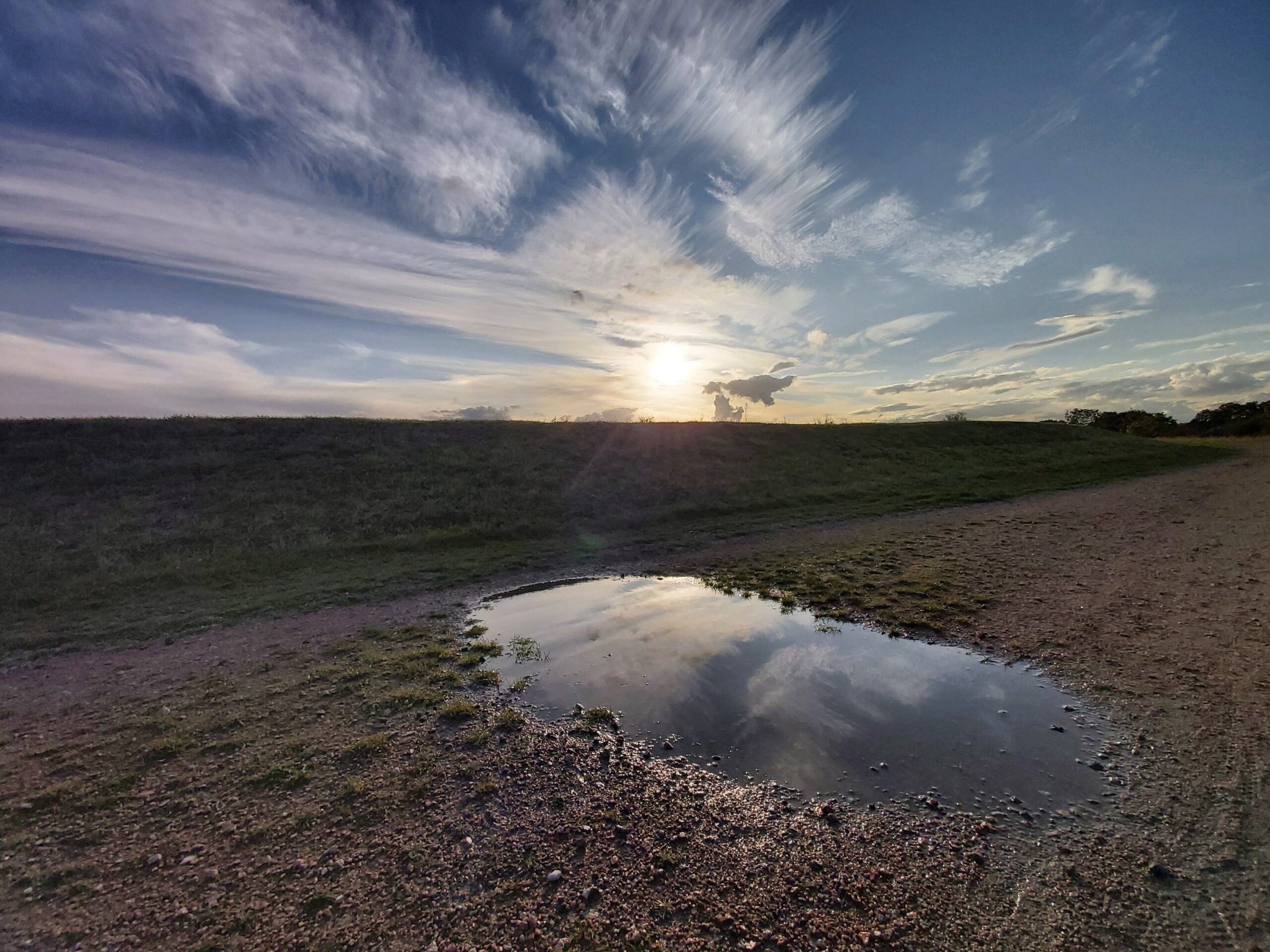 A cloudy reflection in a puddle in Hoo, Medway, England