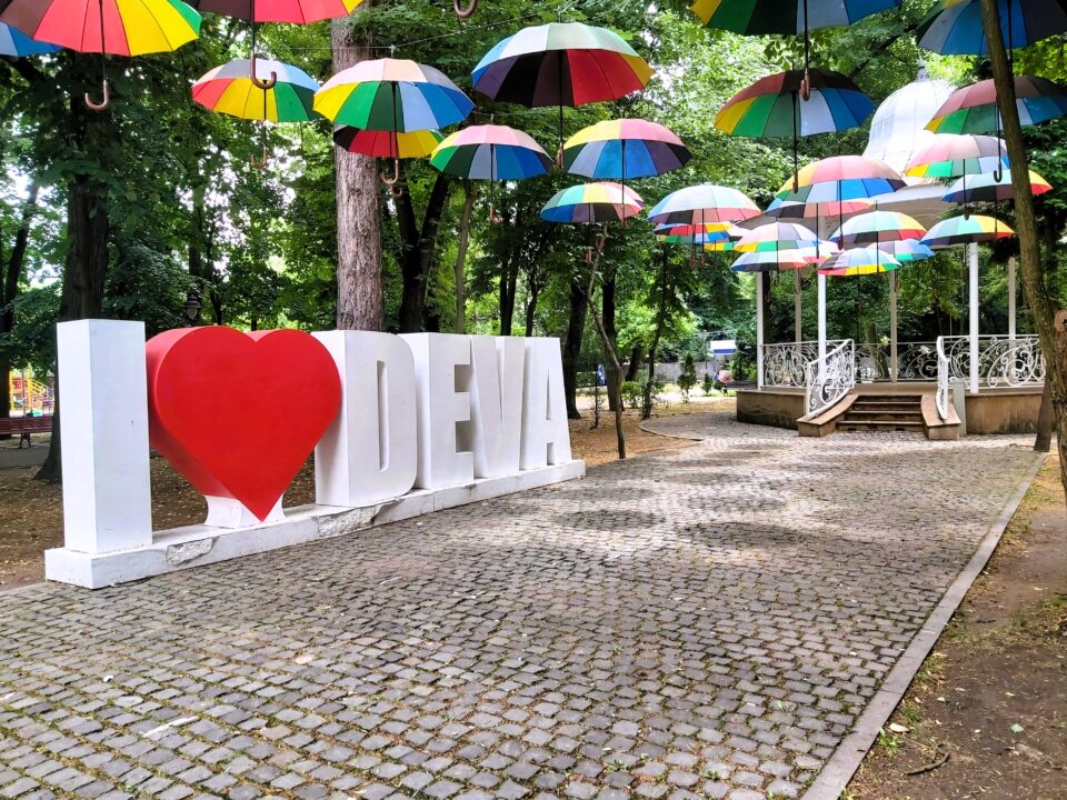 An "I love Deva" art installation with multi-coloured umbrellas in Deva, Romania