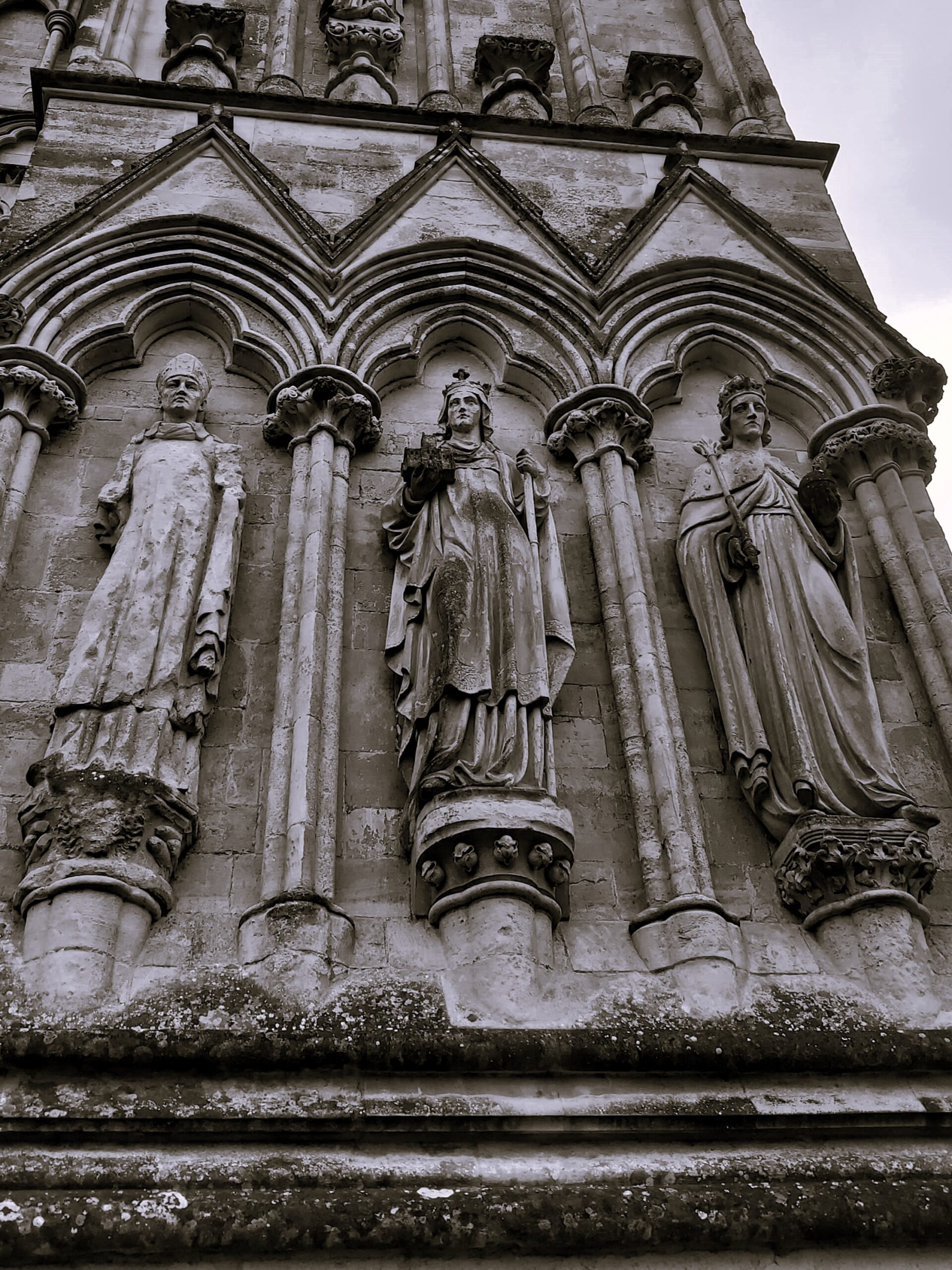 A black and white image of carvings on Winchester Cathedral, England