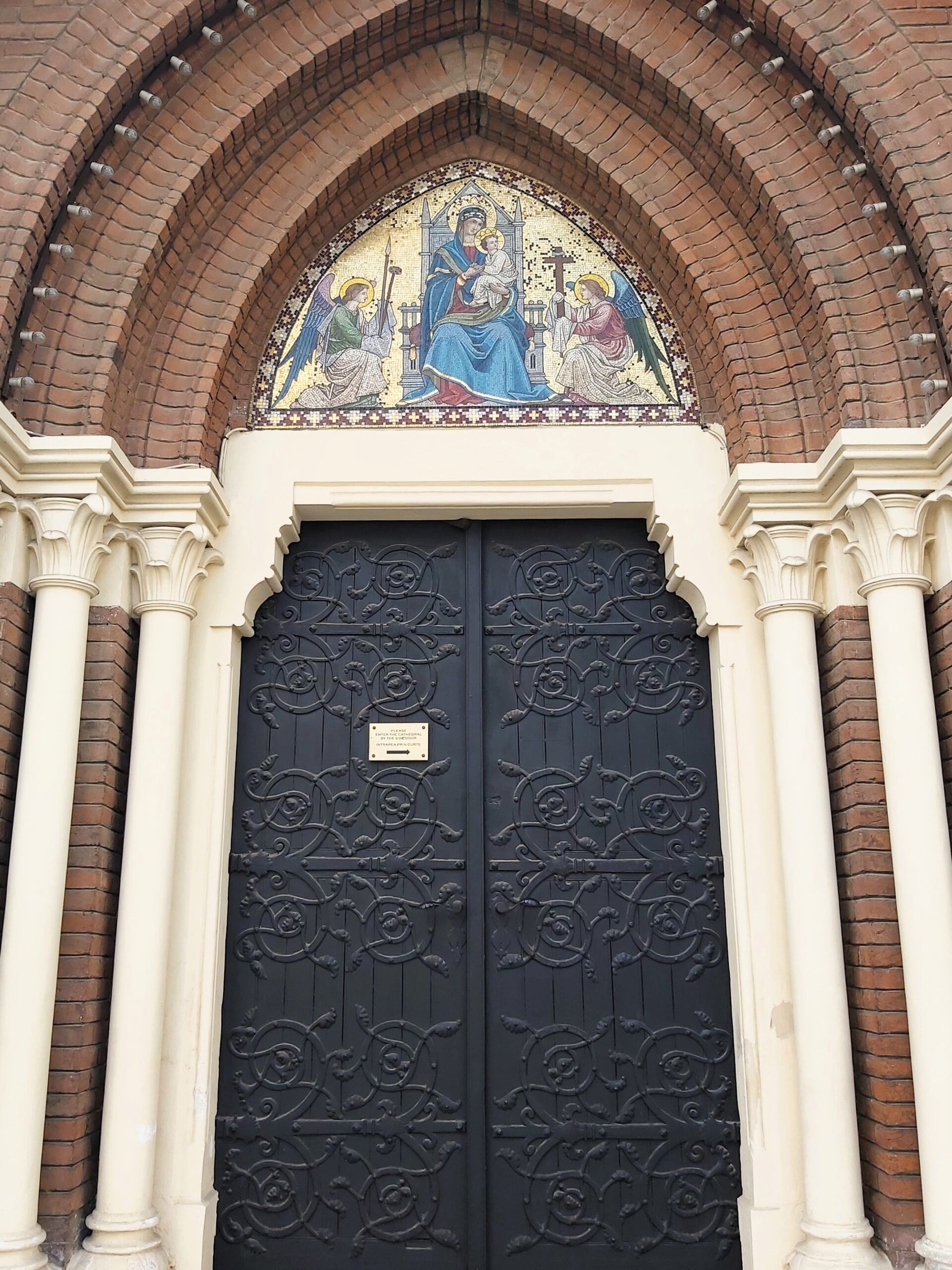 A church door with gold painting above in București, Romania