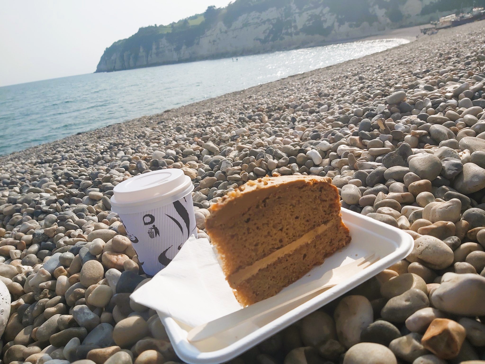 Coffee and cake on the pebbly beach at Beer, Devon, England.