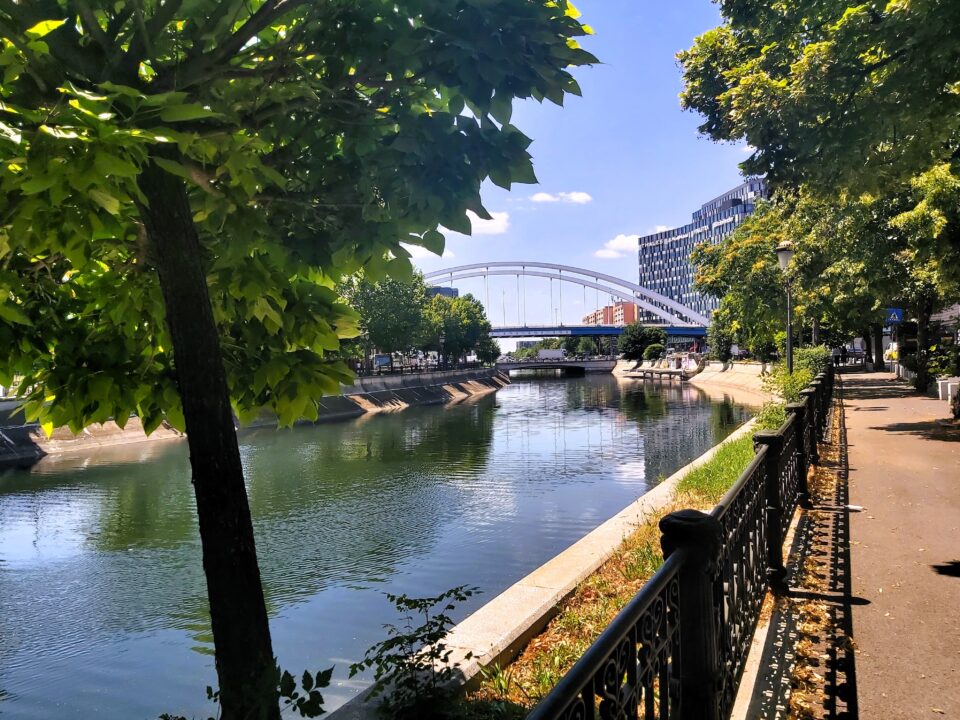 A modern white bridge over the river in București, Romania
