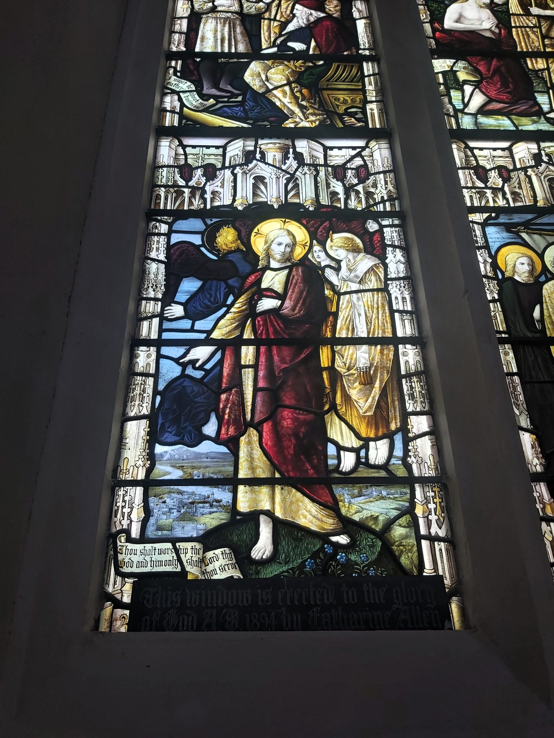 A close up of a stained glass window depicting Jesus in St Mary's Church, Ware, England
