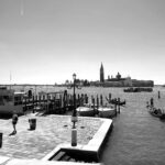 A black and white shot of the canal in Venice, Italy