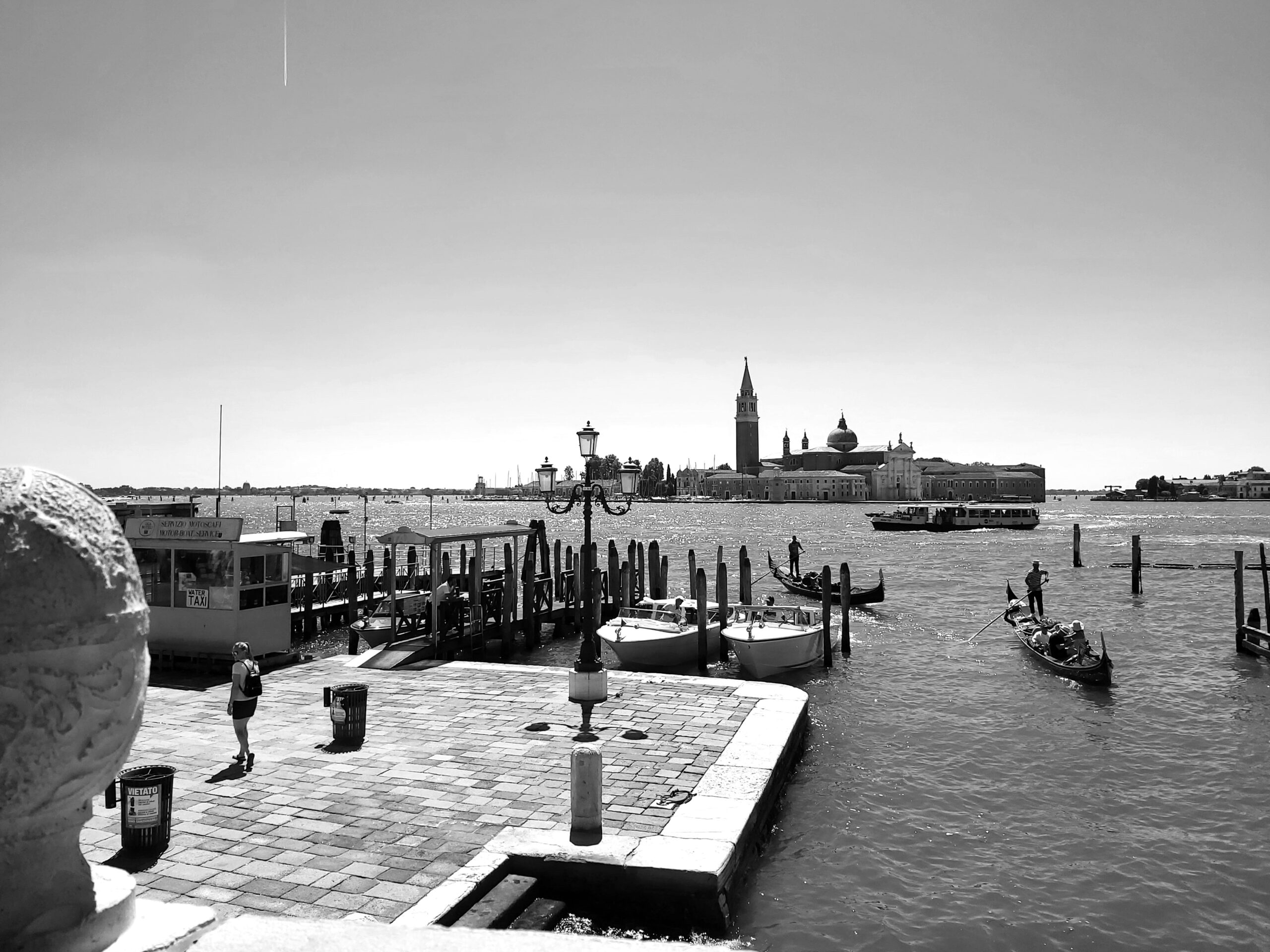 A black and white shot of the canal in Venice, Italy