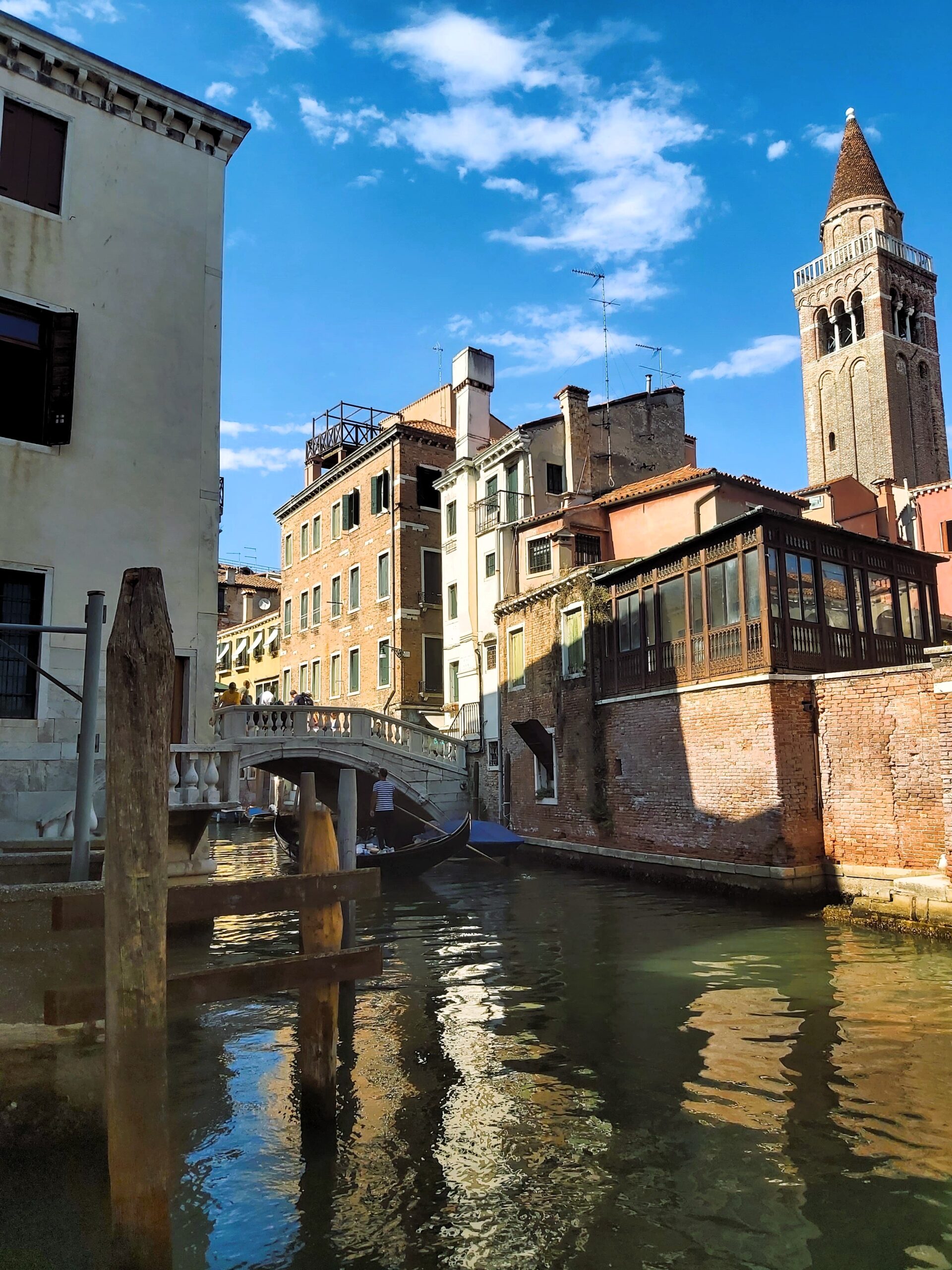 A view of several different styled buildings and a bridge in Venice, Italy