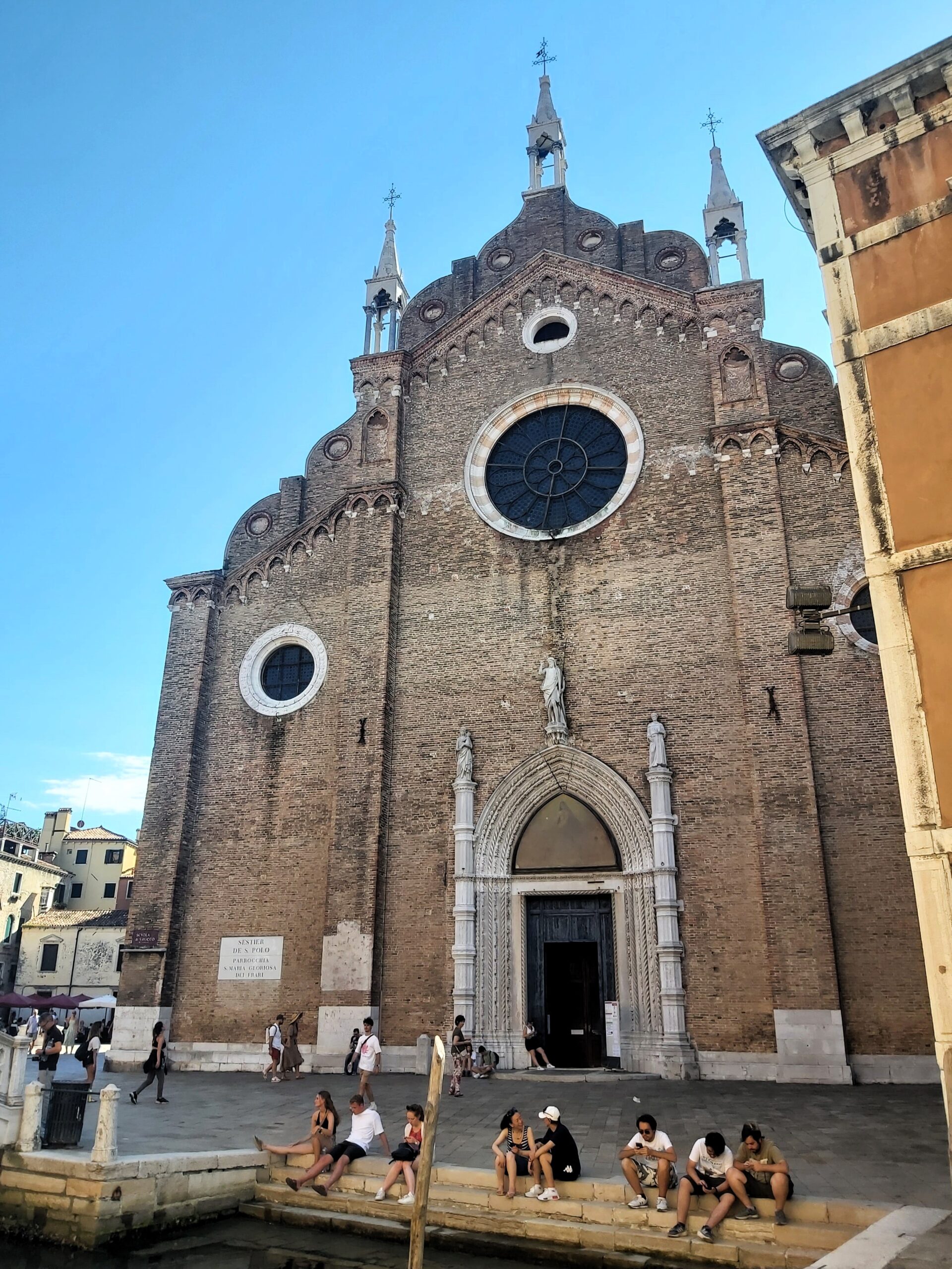 A church with arched doorway and circular window in Venice, Italy
