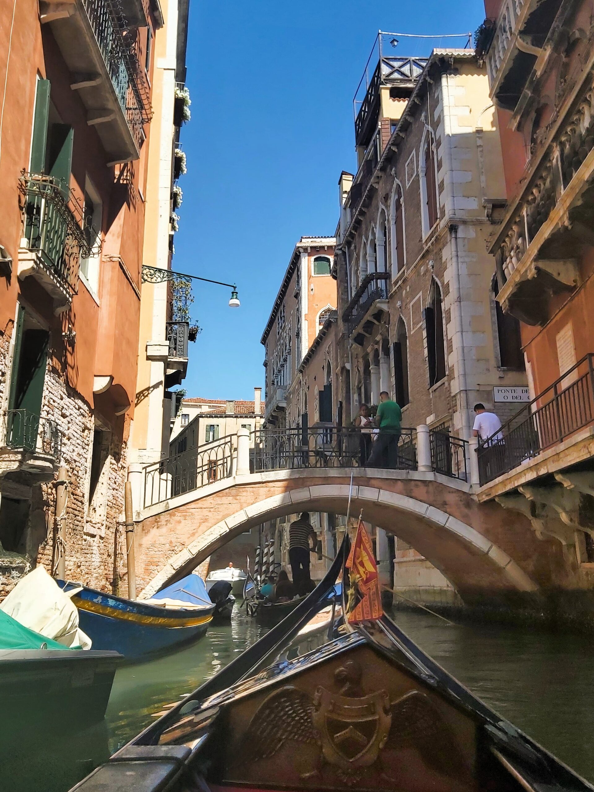 A view from a gondola approaching a bridge in Venice, Italy