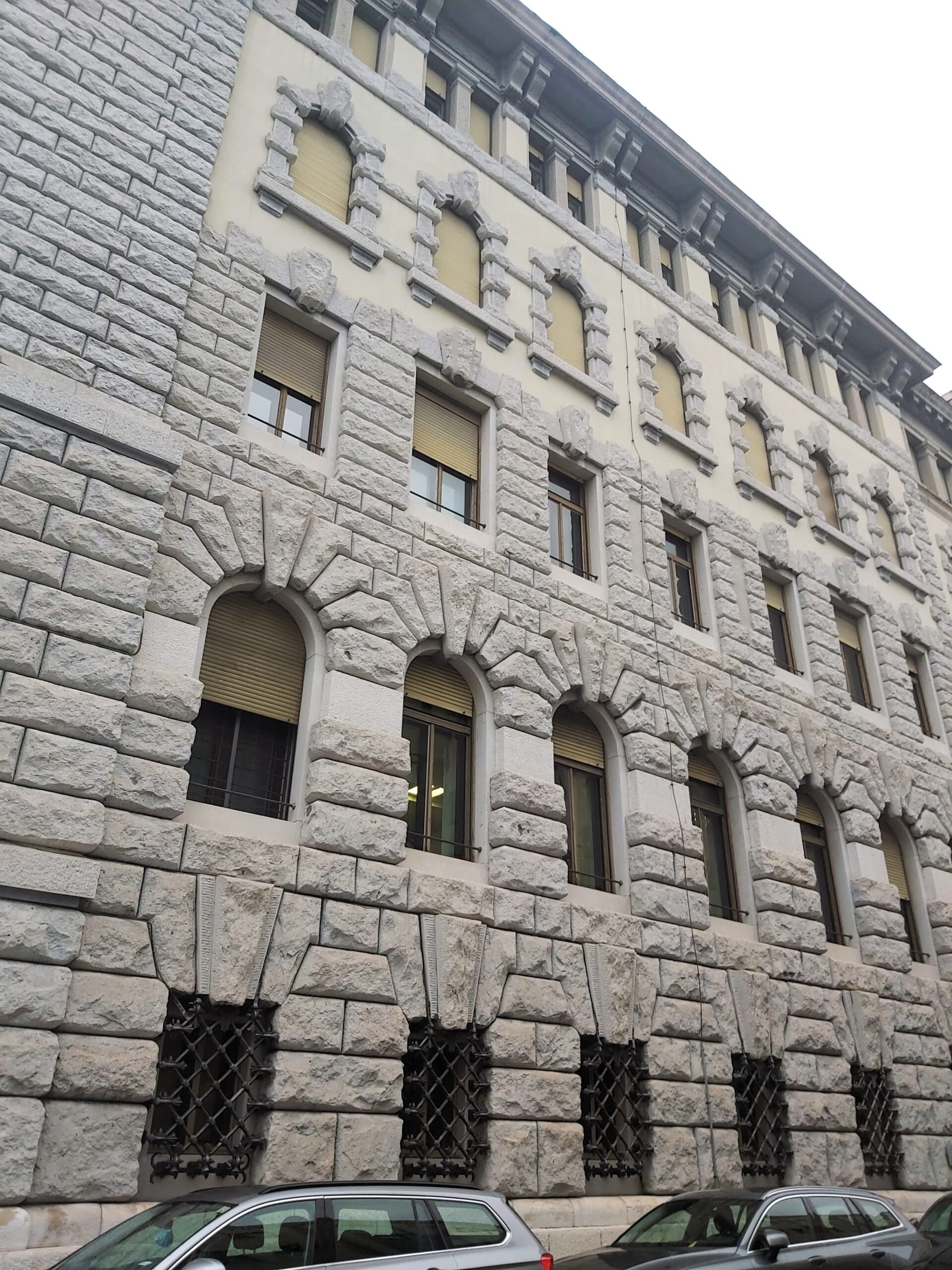 The fancy facade of a stone building in Trieste, Italy