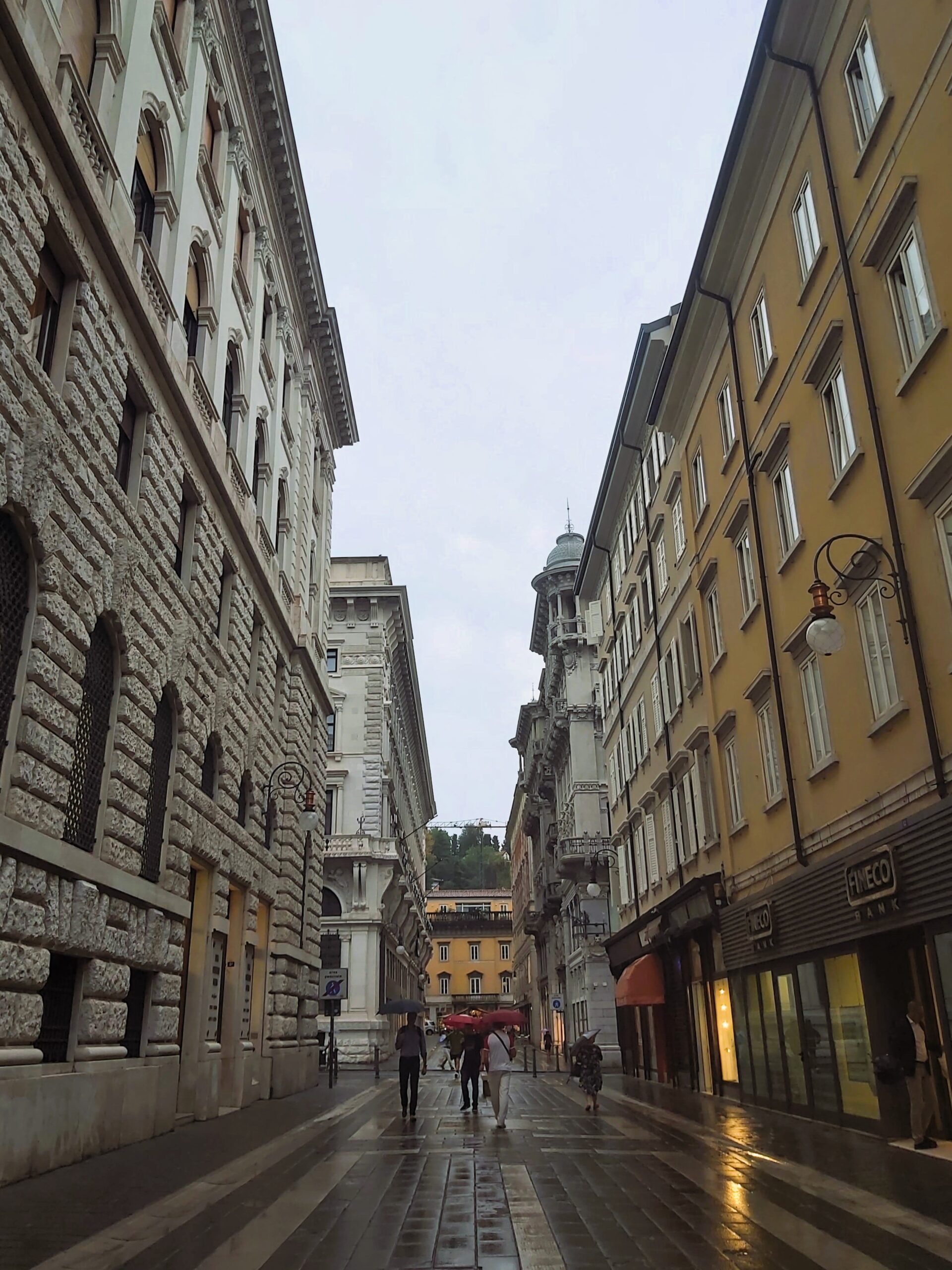 A rainy street scene in Trieste, Italy