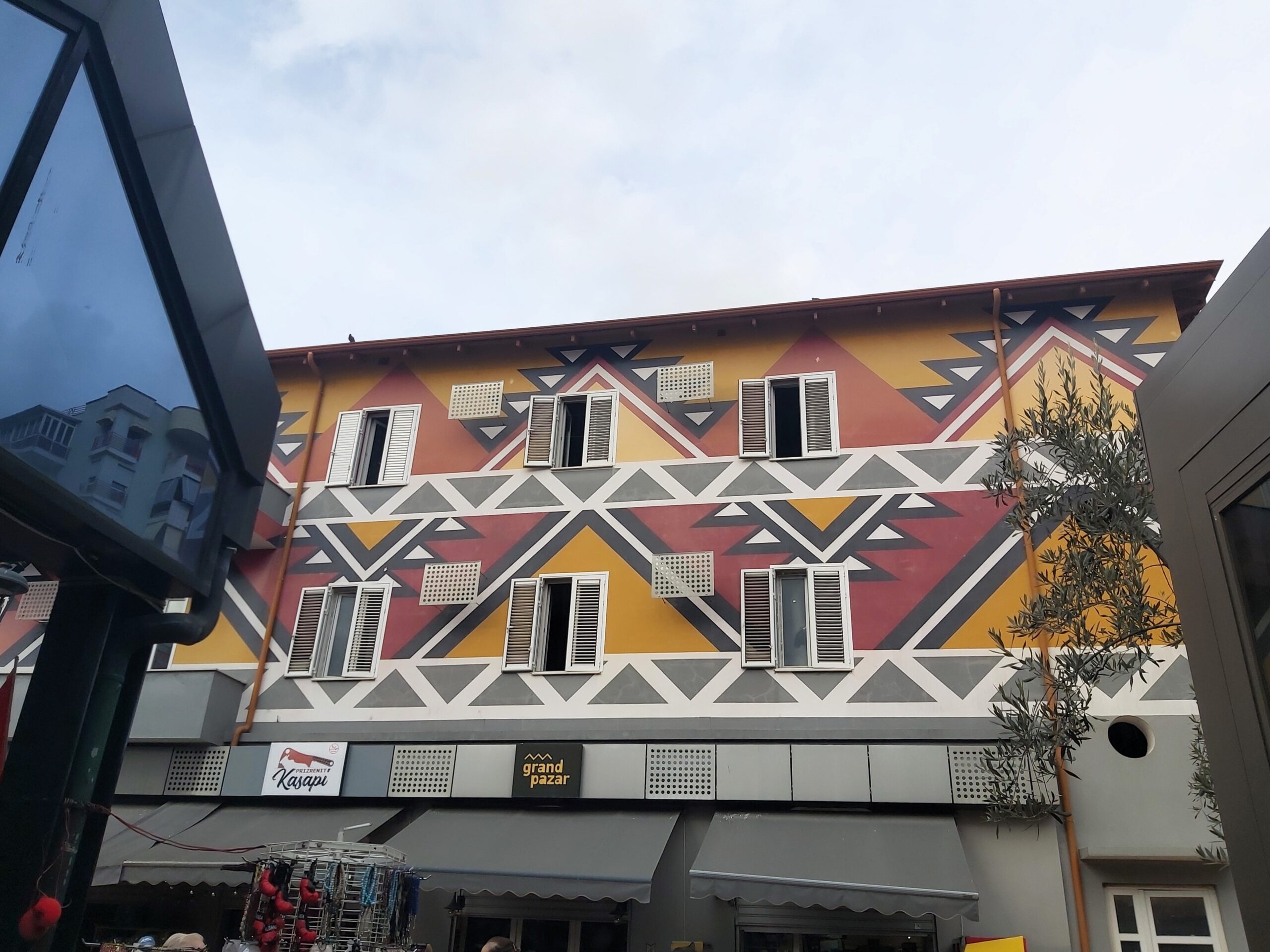 A pretty building with colourful traditional patterns painted on it in Tirana, Albania
