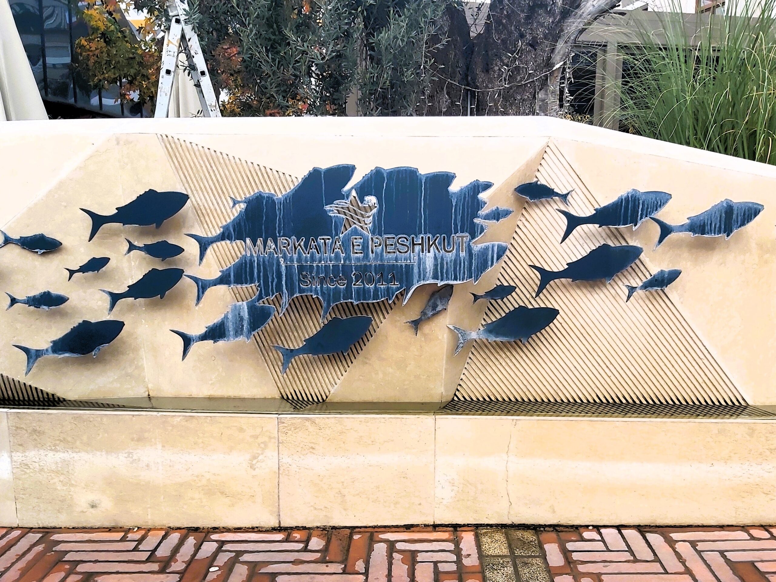Blue metal fish market sign in Tirana, Albania
