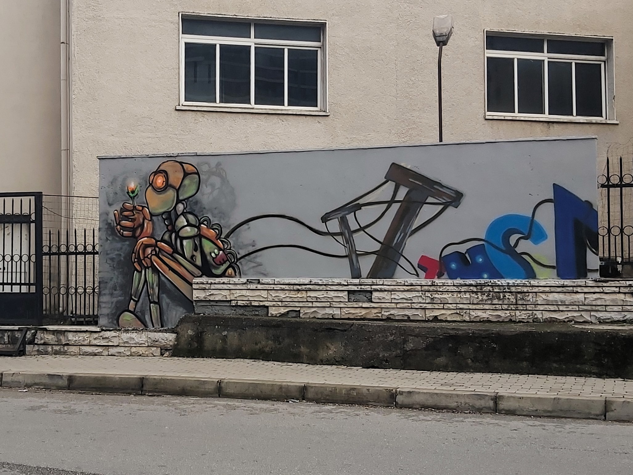 A thoughtful looking robot mural. Possibly post apocalyptic. In Tirana, Albania.