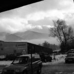 A black and white shot of misty mountains in Bansko, Bulgaria