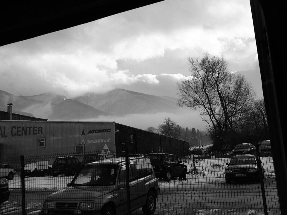 A black and white shot of misty mountains in Bansko, Bulgaria