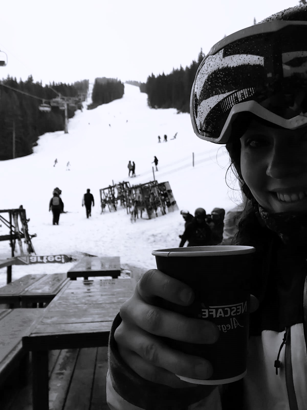 A black and white shot of Wandering Lewis drinking hot wine on the mountain in Bansko, Bulgaria