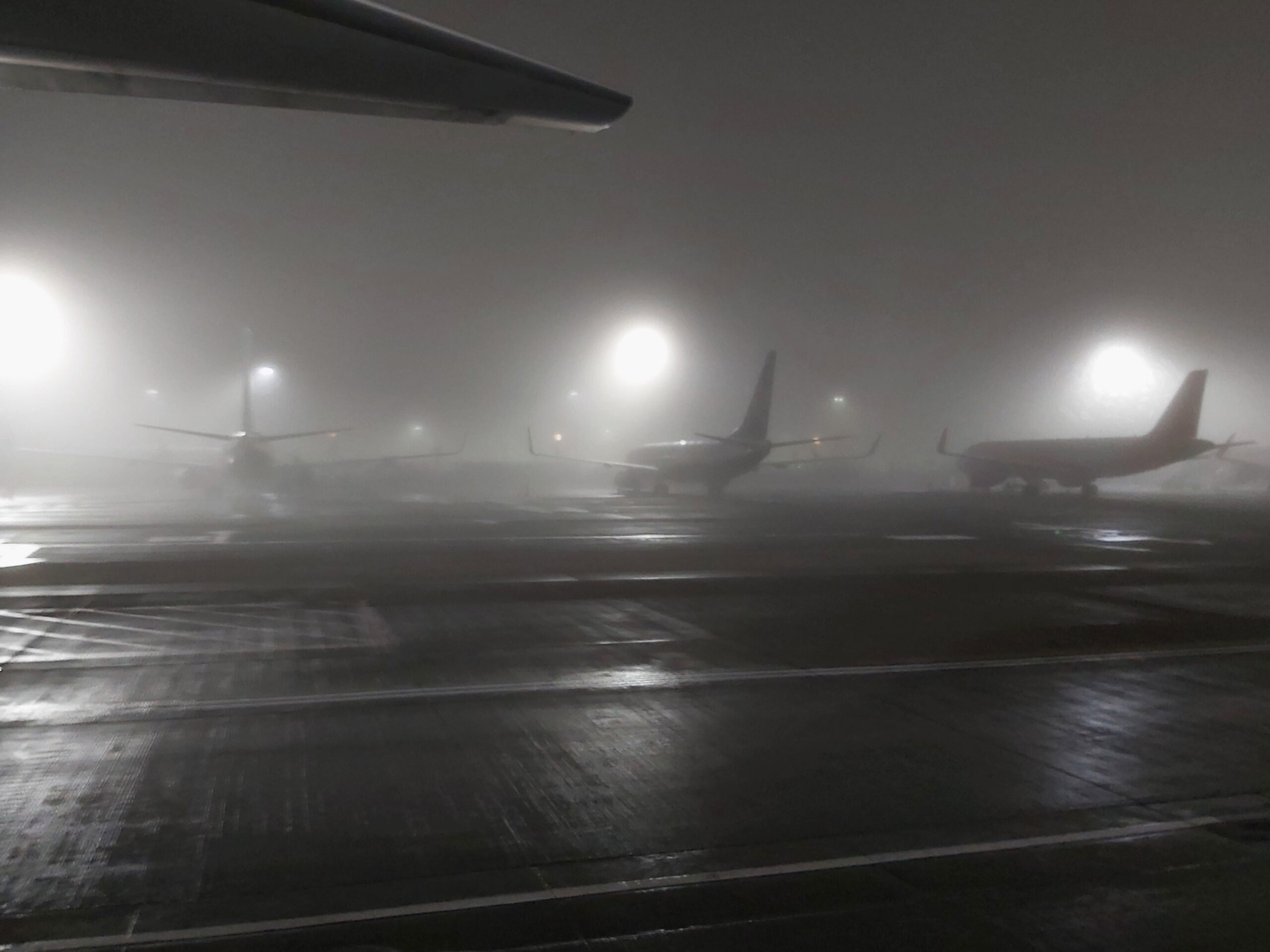Planes in the mist at Stansted Airport, England.