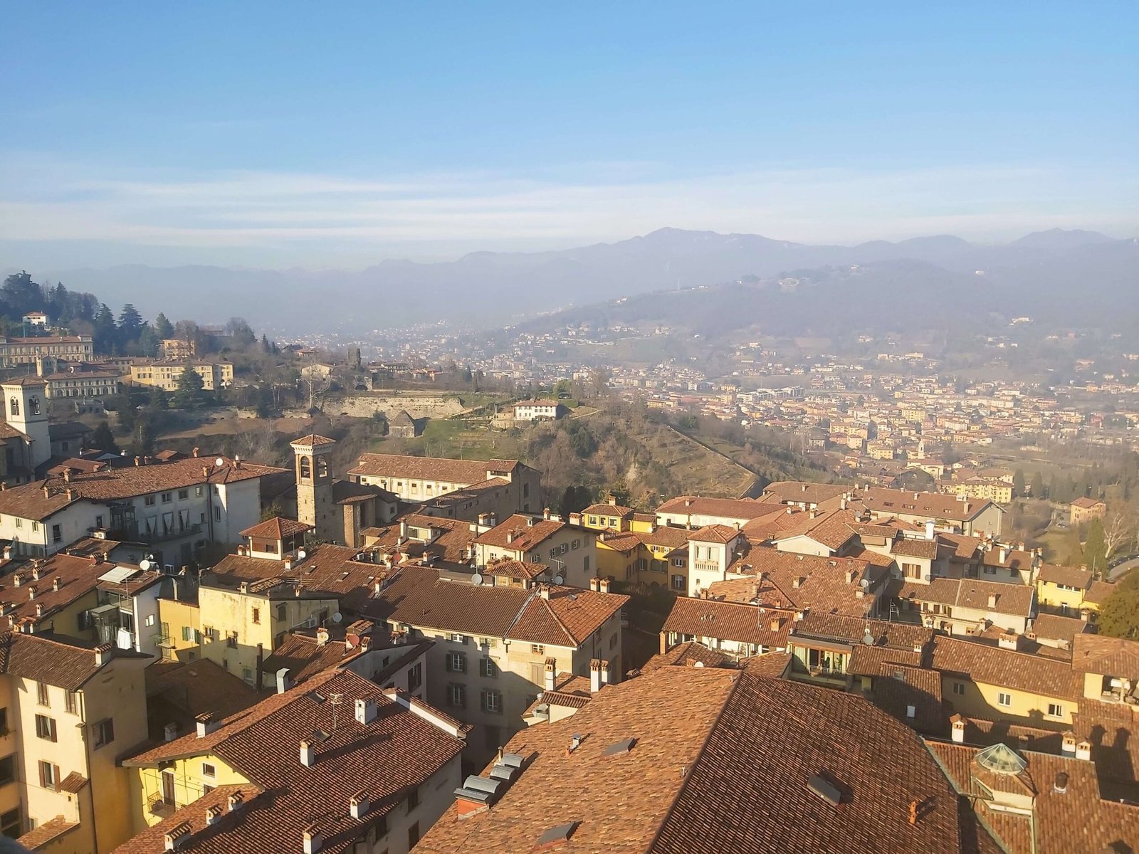 An aerial view of Bergamo city and the mountains in the distance