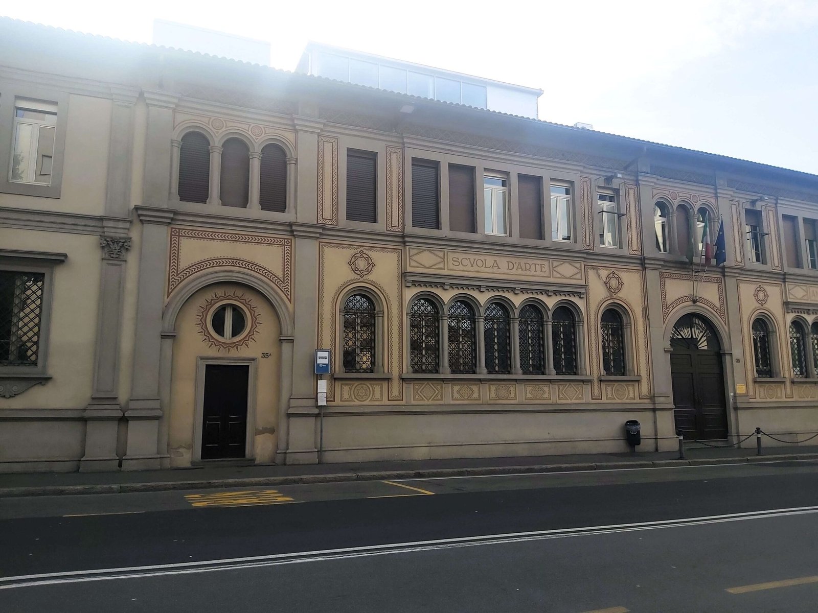 An art school in Bergamo, delicate details in brown contrast against the cream exterior